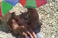 Threesome sex fun on public beach caught on voyeur cam Thumb