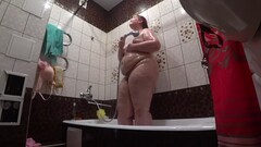 Lesbian has installed a hidden camera in the bathroom at his girlfriend. Peeping behind a bbw with a Thumb